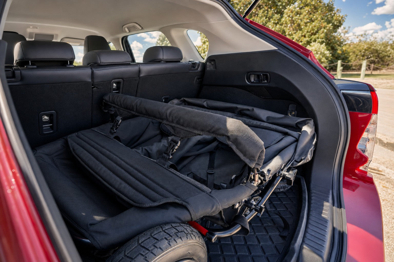 A KinderPod folded flat in a car boot